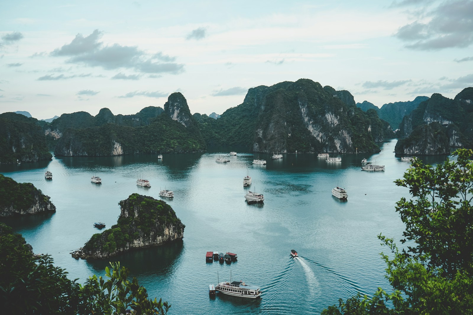 Traveler using smartphone with Ha Long Bay scenery for maps in Vietnam